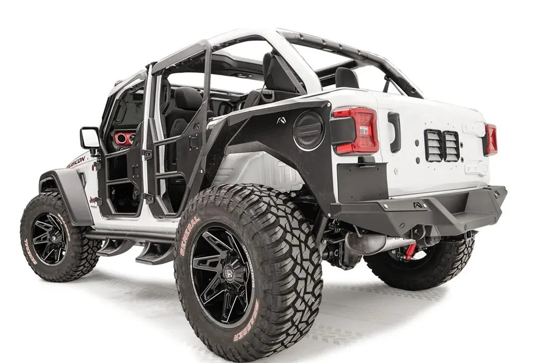 White Jeep Wrangler JL with Fab Fours rear bumper and license plate bracket under the driver-side taillight, driver-side rear three-quarter view