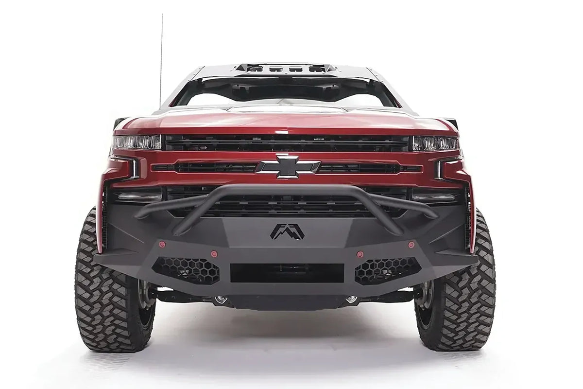 Textured black Fab Fours driving/fog light covers installed on a Vengeance bumper on a Chevrolet Silverado