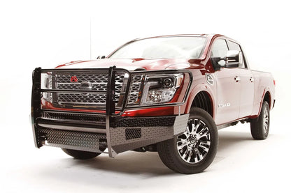 Fab Fours Black Steel front bumper with full guard on a red Nissan TITAN XD, driver-side front three-quarter view, showing the full grille guard, diamond-plate bumper and light openings