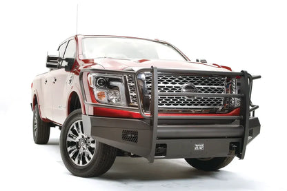 Fab Fours Black Steel Elite front bumper with full guard on a red Nissan TITAN XD, driver-side front three-quarter view, showing the full grille guard, headlight hoops and mesh light openings