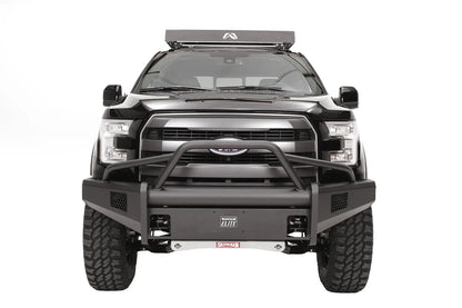 Fab Fours Elite front guard plate on a black Ford F-150, straight-on front view, shown in the center of an Elite bumper with pre-runner guard and mesh light openings