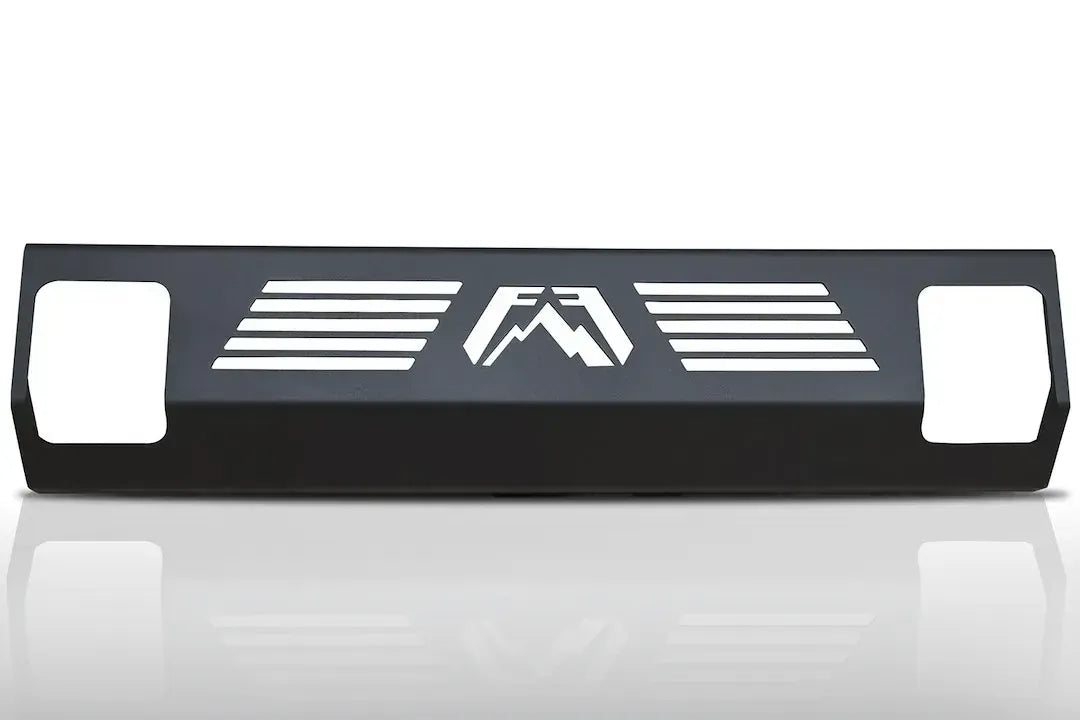 Fab Fours steel hi-flow lower guard for RGAIR-compatible bumpers in matte black, showing slotted air vents beside a center Fab Fours logo cutout and openings at each end on a white background