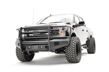 Fab Fours Elite adaptive cruise control relocation bracket on a black Ford F-150, driver-side front three-quarter view, showing the sensor plate in an Elite bumper with full guard