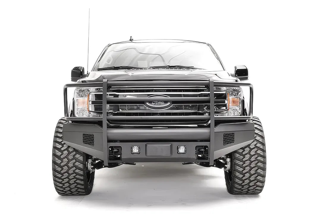 Fab Fours Elite adaptive cruise control relocation bracket on a black Ford F-150, straight-on front view, showing the centered sensor plate in an Elite bumper with full guard