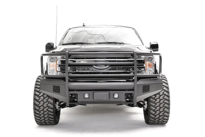 Fab Fours Elite adaptive cruise control relocation bracket on a black Ford F-150, straight-on front view, showing the centered sensor plate in an Elite bumper with full guard