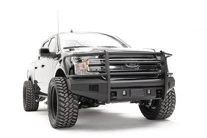 Fab Fours Elite adaptive cruise control relocation bracket on a black Ford F-150, passenger-side front three-quarter view, showing the relocated sensor plate in an Elite bumper with full guard