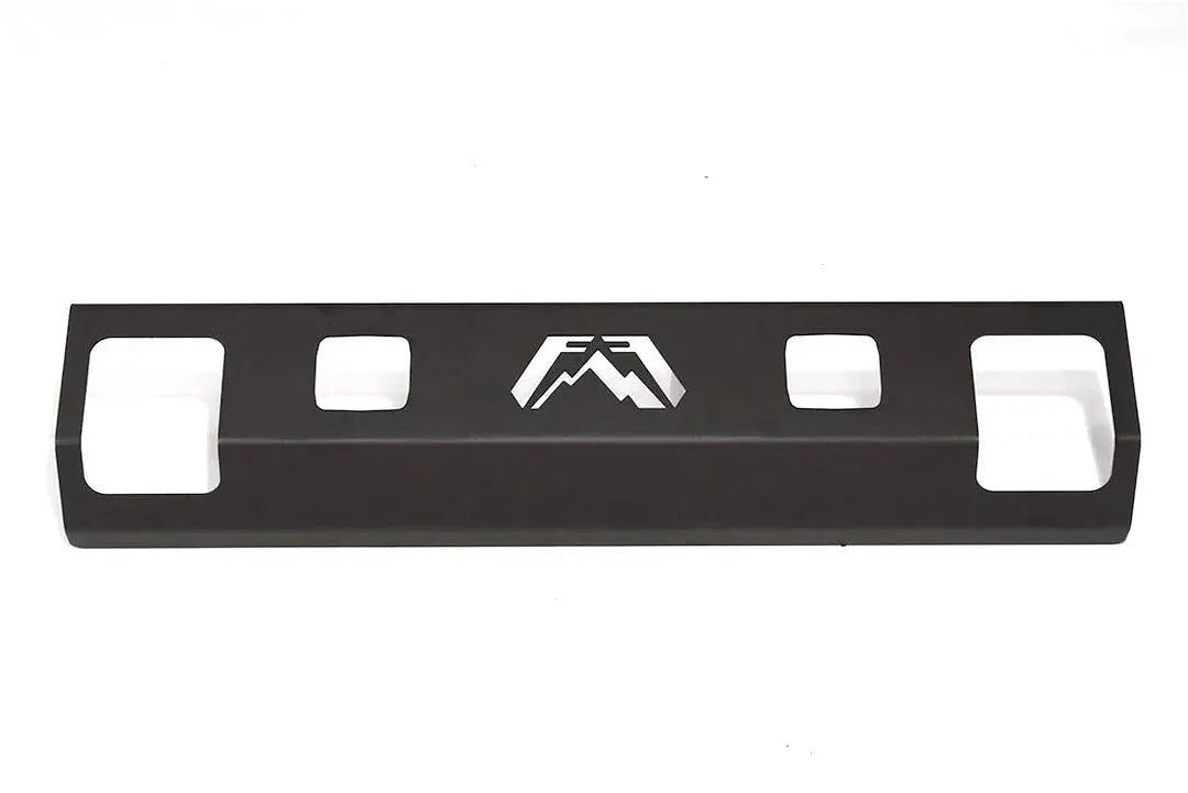 Fab Fours steel lower guard with light cut-outs in black powder coat, straight-on front view, showing two square pod light openings beside the cut-out Fab Fours logo and the shackle openings at each end