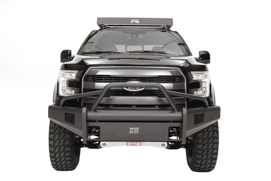 Fab Fours bent flange roof rack face plate with Fab Fours logo on the front of a roof rack on a lifted black Ford F-150, front view, with Fab Fours Black Steel Elite front bumper and pre-runner guard