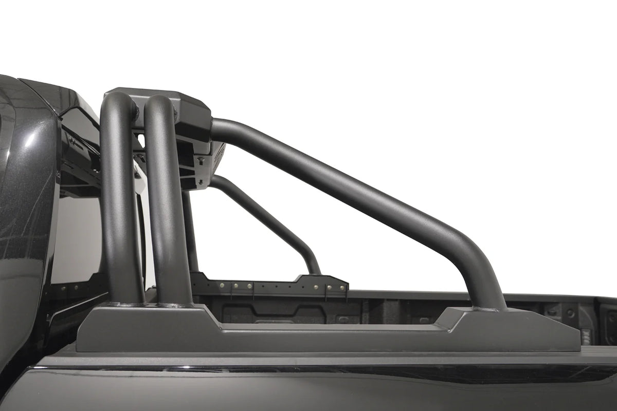 Fab Fours Sport Rack on a black pickup truck, driver-side profile, showing the swept tubular bars and rail-mounted base plates along the bed