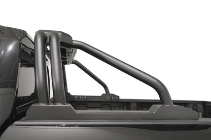 Fab Fours Sport Rack on a black pickup truck, driver-side profile, showing the swept tubular bars and rail-mounted base plates along the bed