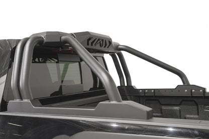 Fab Fours Sport Rack on a black pickup truck, driver-side view, showing the double tubular uprights, swept rear bars and logo-cut center housing behind the cab