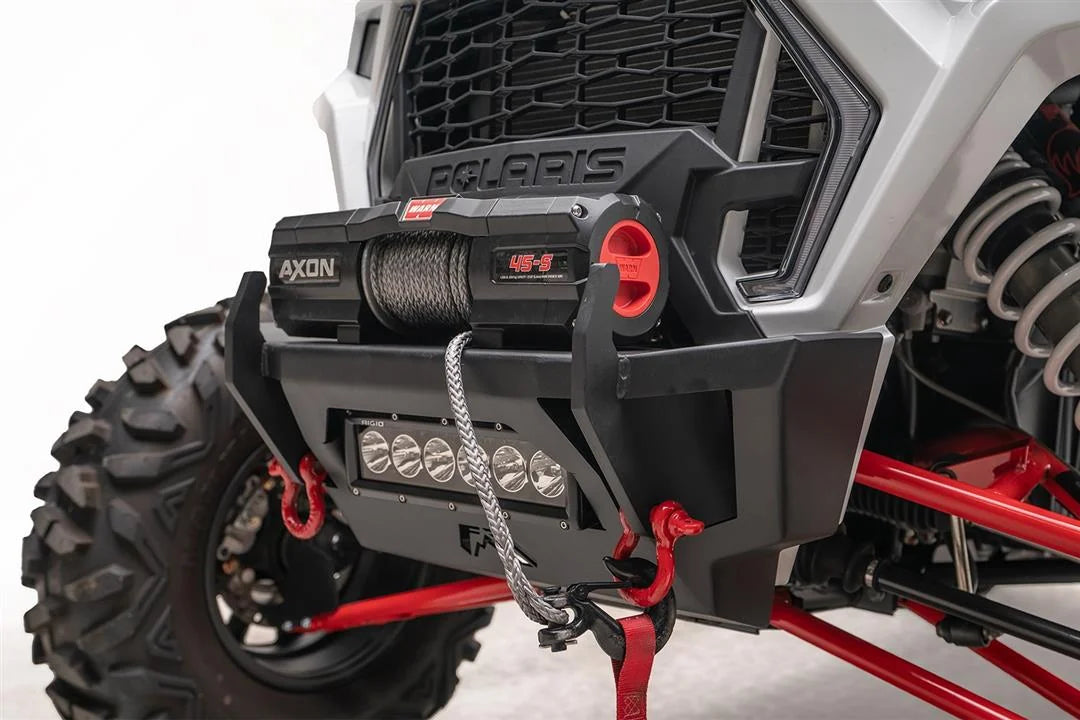 Close-up of Fab Fours SxS winch bumper with Warn Axon 45-S winch, synthetic winch line, Rigid LED light bar, and red D-ring shackles
