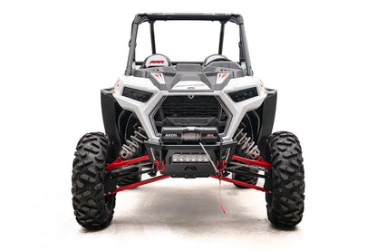 Fab Fours SxS winch bumper on a white Polaris RZR XP, front view, with Warn Axon winch, LED light bar, and red D-ring shackles