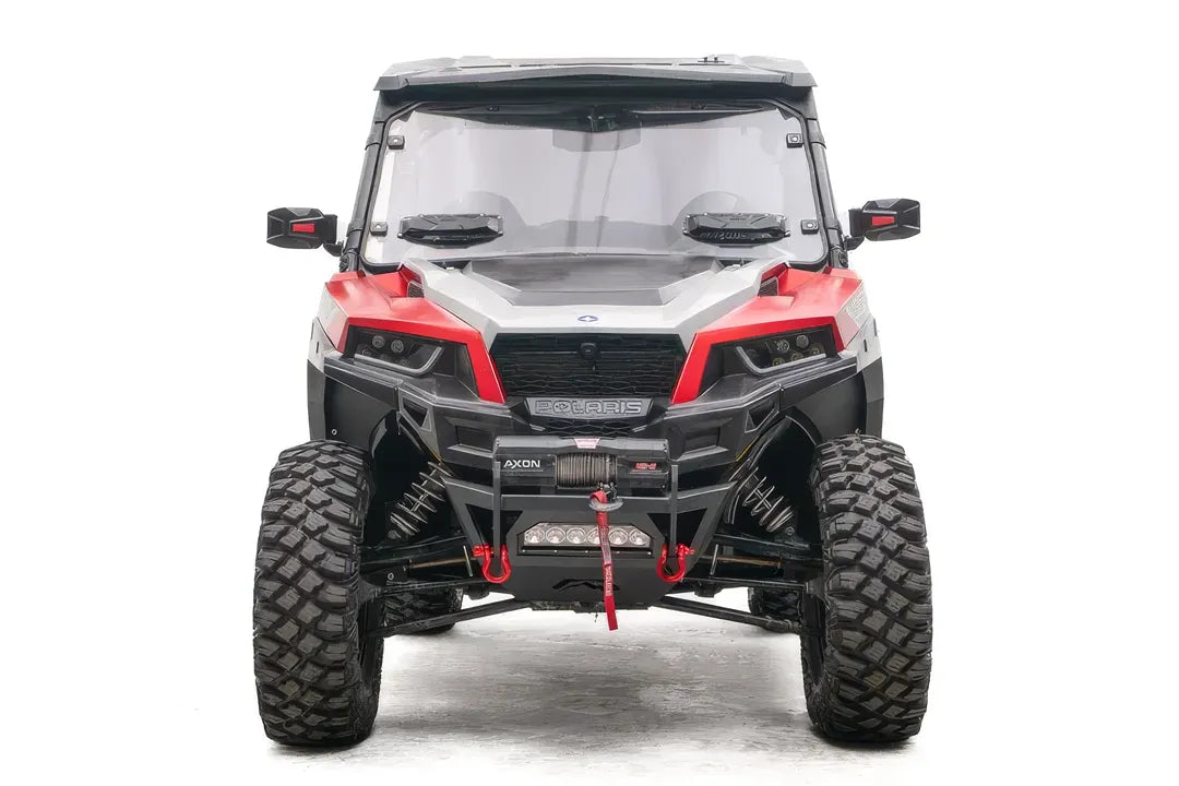 Fab Fours SxS winch bumper on a red Polaris General 1000, front view, with Warn Axon winch, LED light bar, and red D-ring shackles