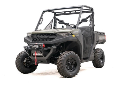 Fab Fours SxS winch bumper on a green Polaris Ranger 1000, driver-side front three-quarter view, with Warn Axon winch and LED light bar