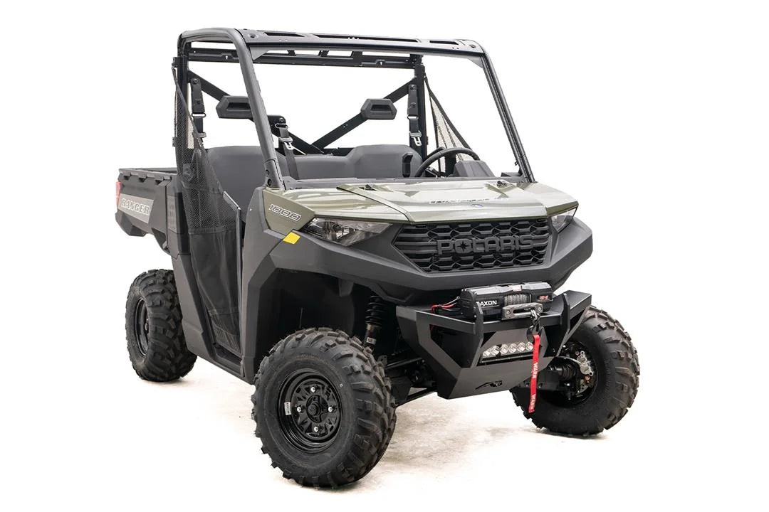 Fab Fours SxS winch bumper on a green Polaris Ranger 1000, passenger-side front three-quarter view, with Warn Axon winch and LED light bar