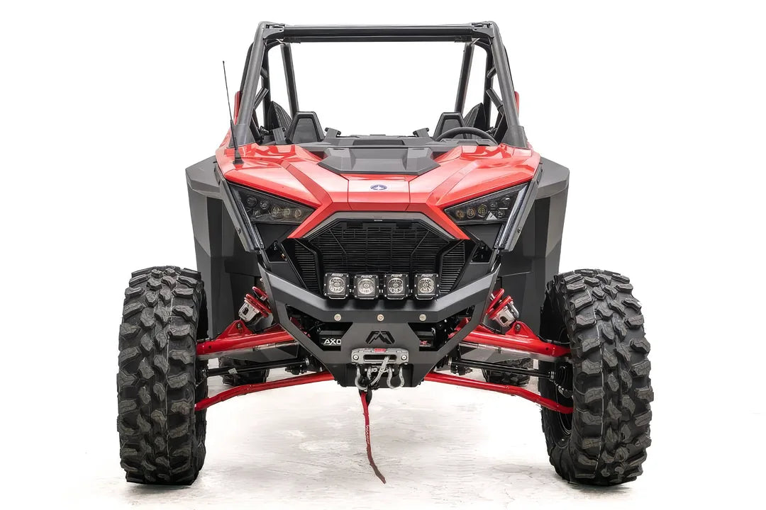 Fab Fours SxS winch bumper on a red Polaris RZR Pro XP, front view, with four cube lights, winch fairlead, and D-ring shackles