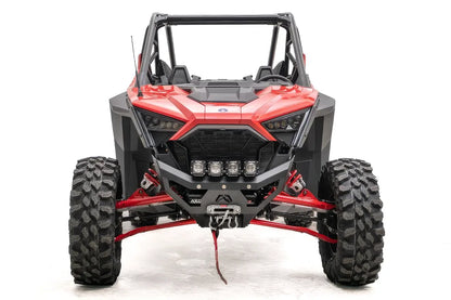Fab Fours SxS winch bumper on a red Polaris RZR Pro XP, front view, with four cube lights, winch fairlead, and D-ring shackles