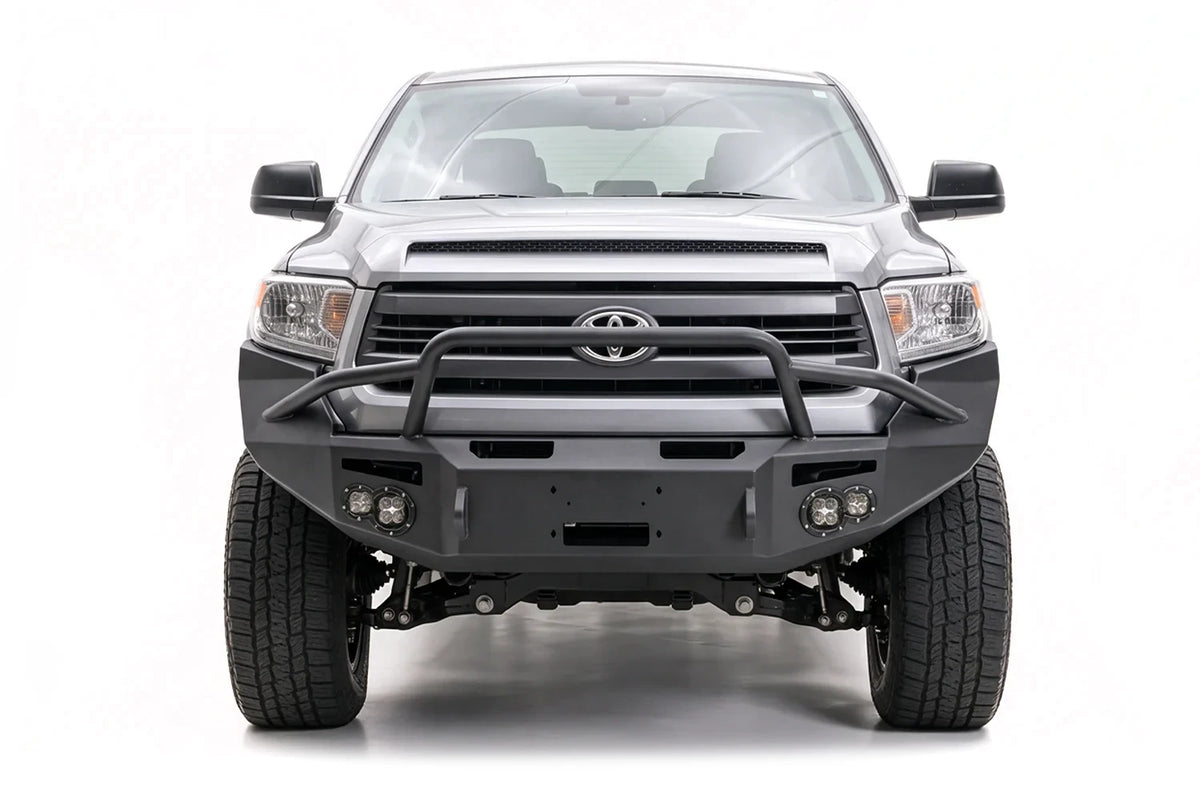 Fab Fours front bumper on a gray Toyota truck, passenger-side front view
