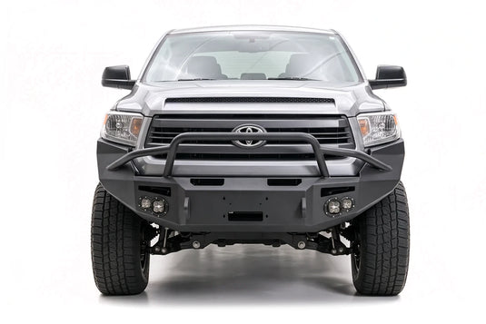 Fab Fours front bumper on a gray Toyota truck, passenger-side front view