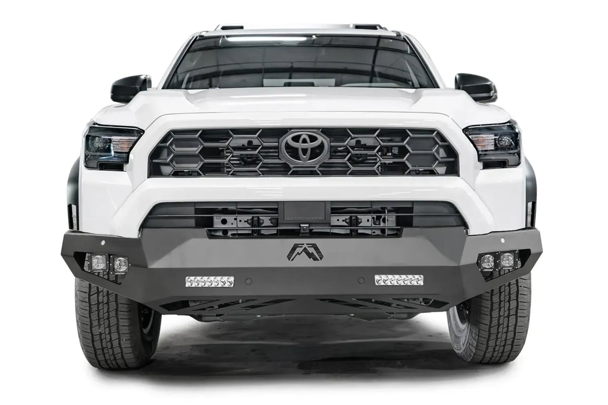 Fab Fours Vengeance front sensor bumper on a white Toyota 4Runner, straight-on front view, showing the angular bumper, LED light bars and cube lights
