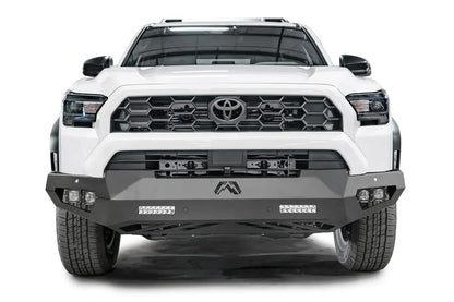 Fab Fours Vengeance front sensor bumper on a white Toyota 4Runner, straight-on front view, showing the angular bumper, LED light bars and cube lights