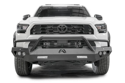 Fab Fours Vengeance front sensor bumper with pre-runner guard on a white Toyota 4Runner, straight-on front view, showing the tube hoop, LED light bars and cube lights