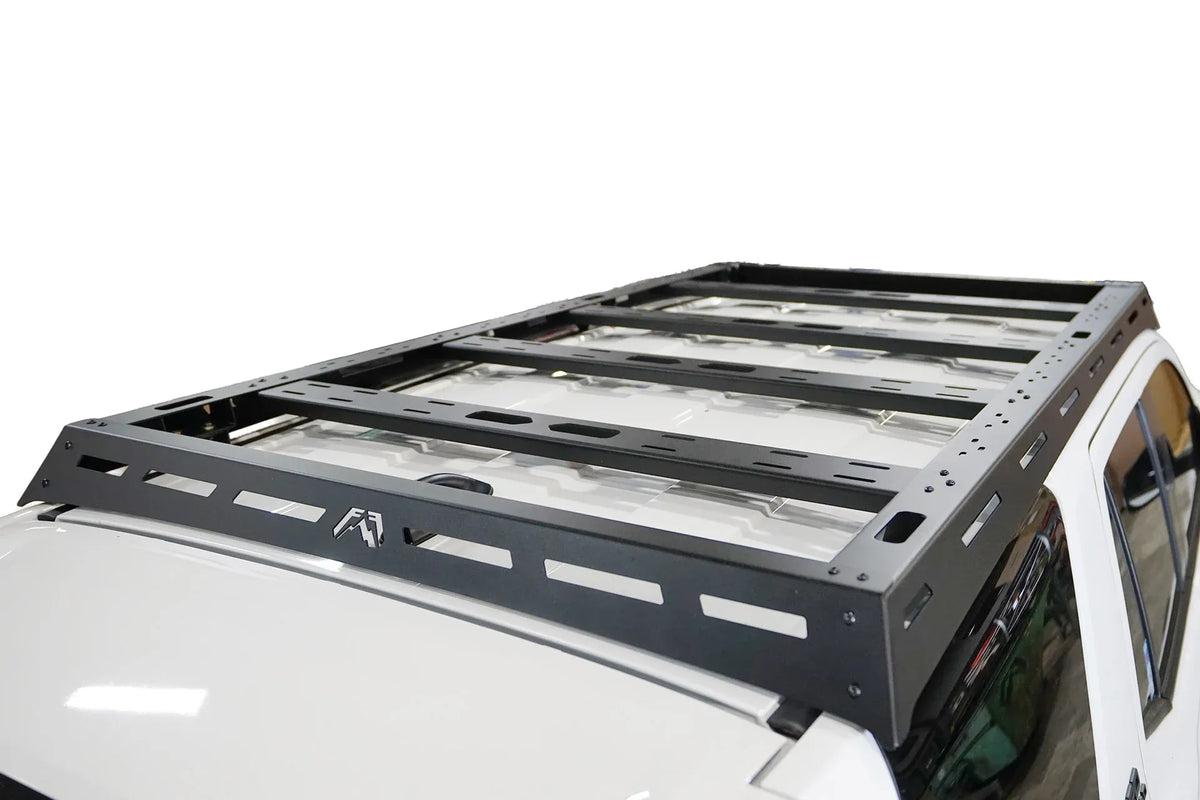 Fab Fours Roof Rack on a white Toyota 4Runner, rear view from above, showing the slotted rear bar with Fab Fours logo, side rails and four cross-members