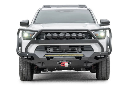 Fab Fours Matrix front winch bumper with full guard on a white Toyota 4Runner, straight-on front view, showing the full guard with light mounts, LED light bar and winch
