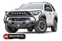 Fab Fours Matrix front winch bumper with full guard on a white Toyota 4Runner, driver-side front three-quarter view, showing the full guard, LED light bar and winch with red hook