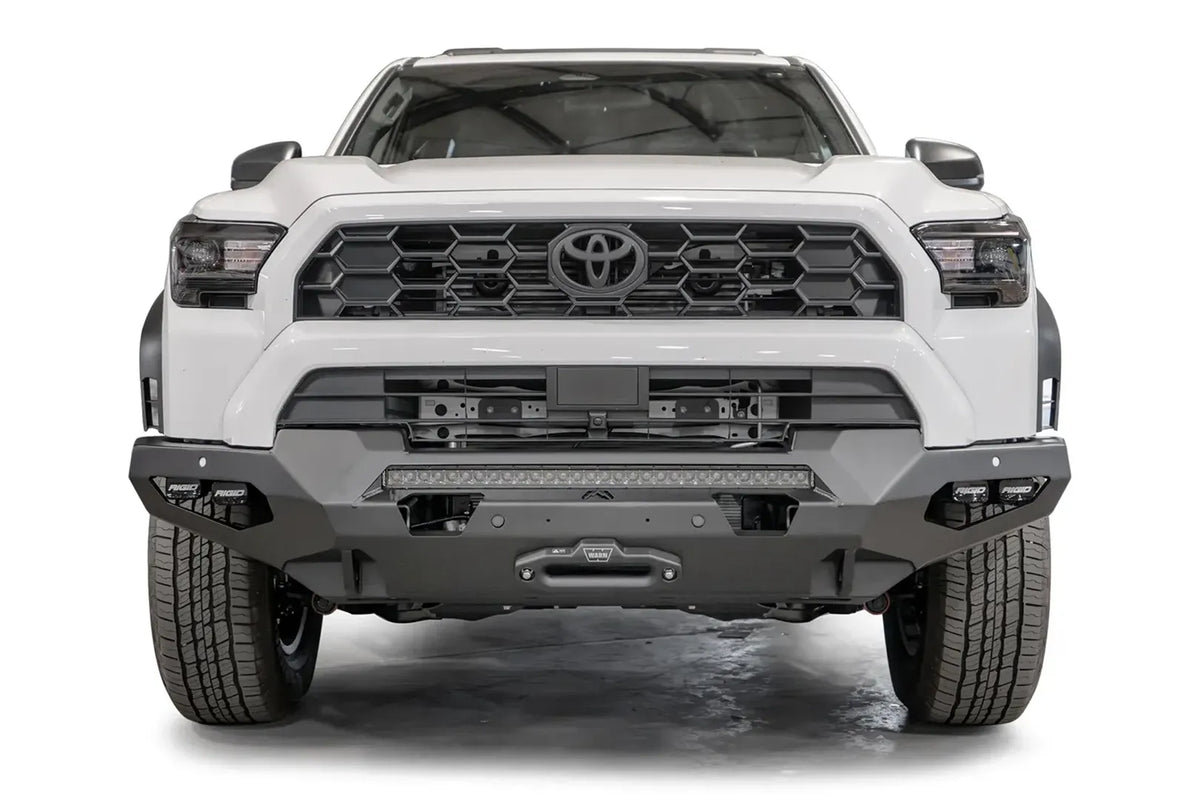 Fab Fours Matrix front winch bumper on a white Toyota 4Runner, straight-on front view, showing the full-width bumper, LED light bar and winch fairlead