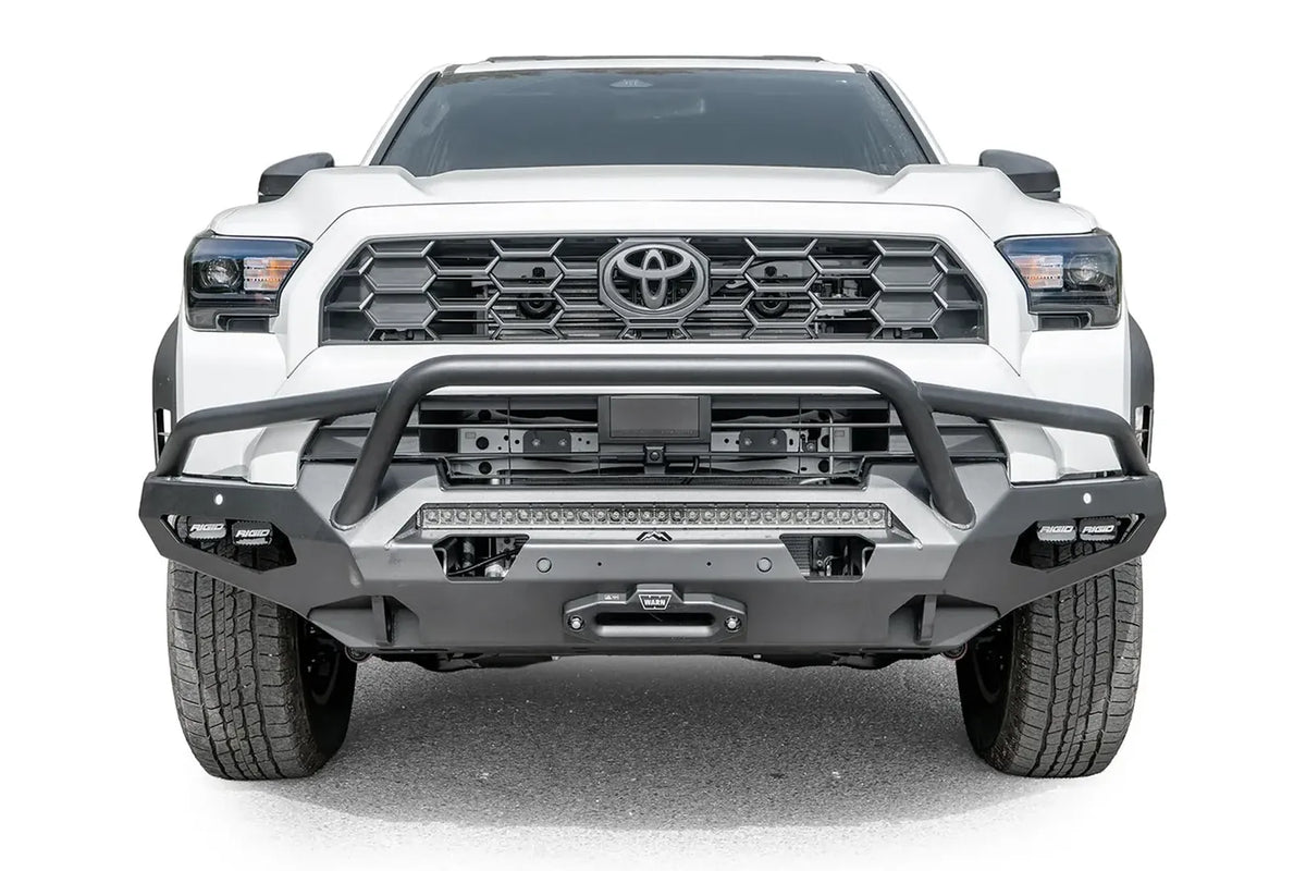 Fab Fours Matrix front winch bumper with pre-runner guard on a white Toyota 4Runner, straight-on front view, showing the tube hoop, LED light bar and winch fairlead