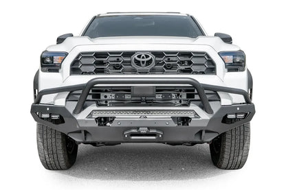 Fab Fours Matrix front winch bumper with pre-runner guard on a white Toyota 4Runner, straight-on front view, showing the tube hoop, LED light bar and winch fairlead