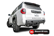 Fab Fours Premium rear bumper on a white Toyota 4Runner, driver-side rear three-quarter view, with D-ring shackles, hitch receiver, and SmartSteel Tested & Validated badge
