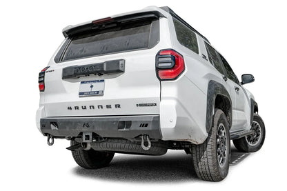 Fab Fours Premium rear bumper on a white Toyota 4Runner, passenger-side rear three-quarter view, with D-ring shackles and hitch receiver