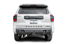 Fab Fours Premium rear bumper on a white Toyota 4Runner, straight rear view, with parking sensors, D-ring shackles, and center hitch receiver