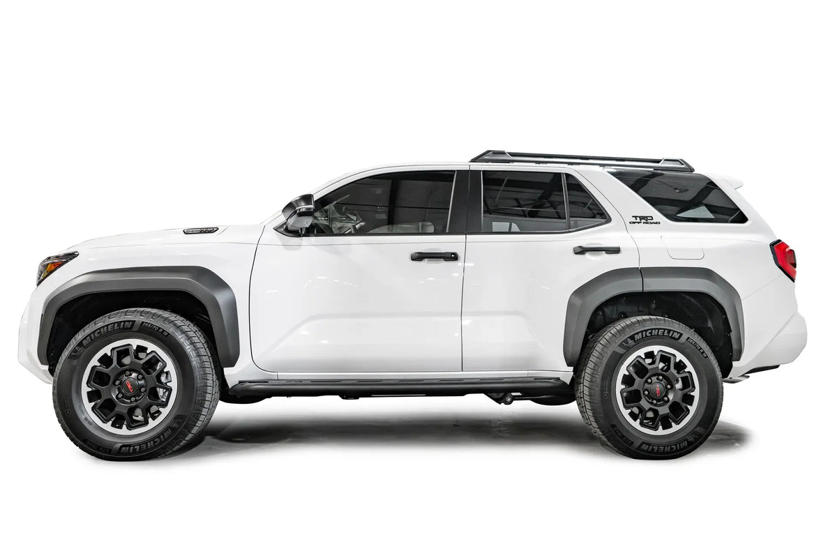 Fab Fours step slider on a white Toyota 4Runner TRD Off-Road, driver-side profile