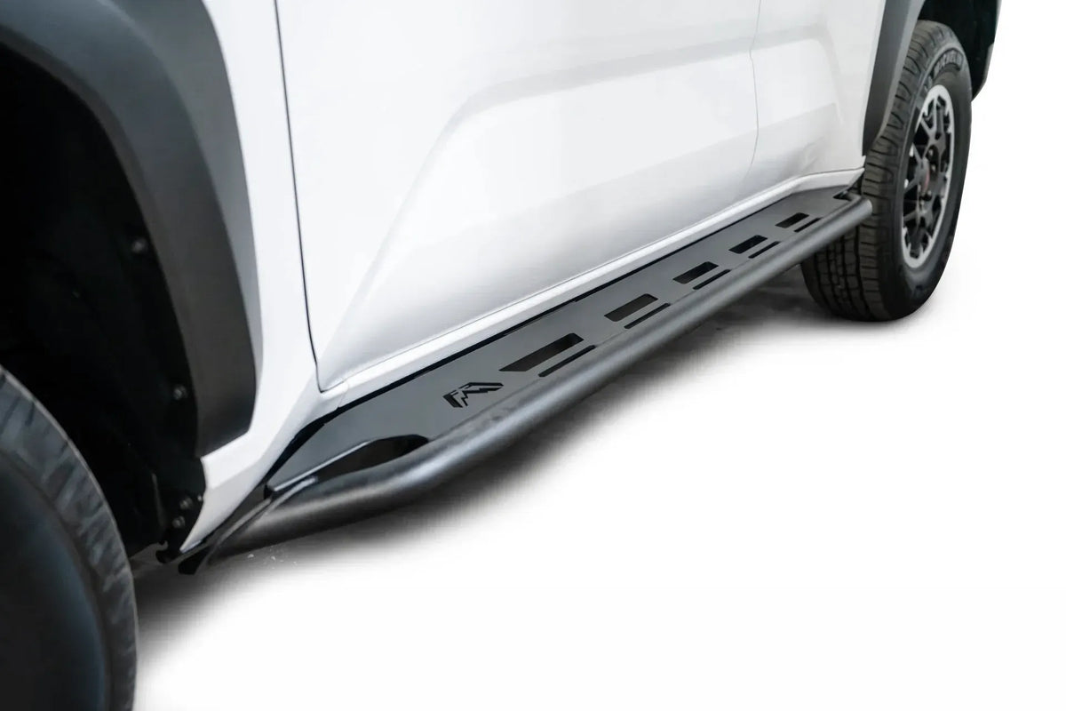 Fab Fours step slider on a white Toyota 4Runner, low angle along the rocker