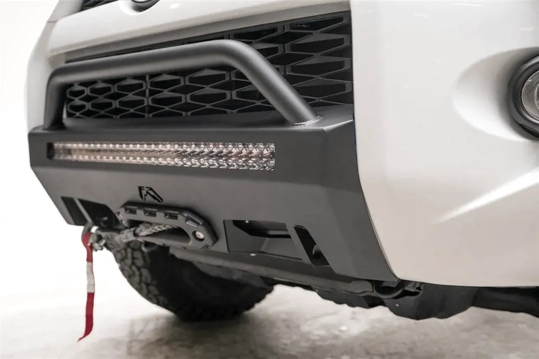 Fab Fours Hidden Winch Mount with low pre-runner guard on a white Toyota 4Runner, close-up of the front corner, showing the pre-runner hoop, LED light bar and fairlead mount