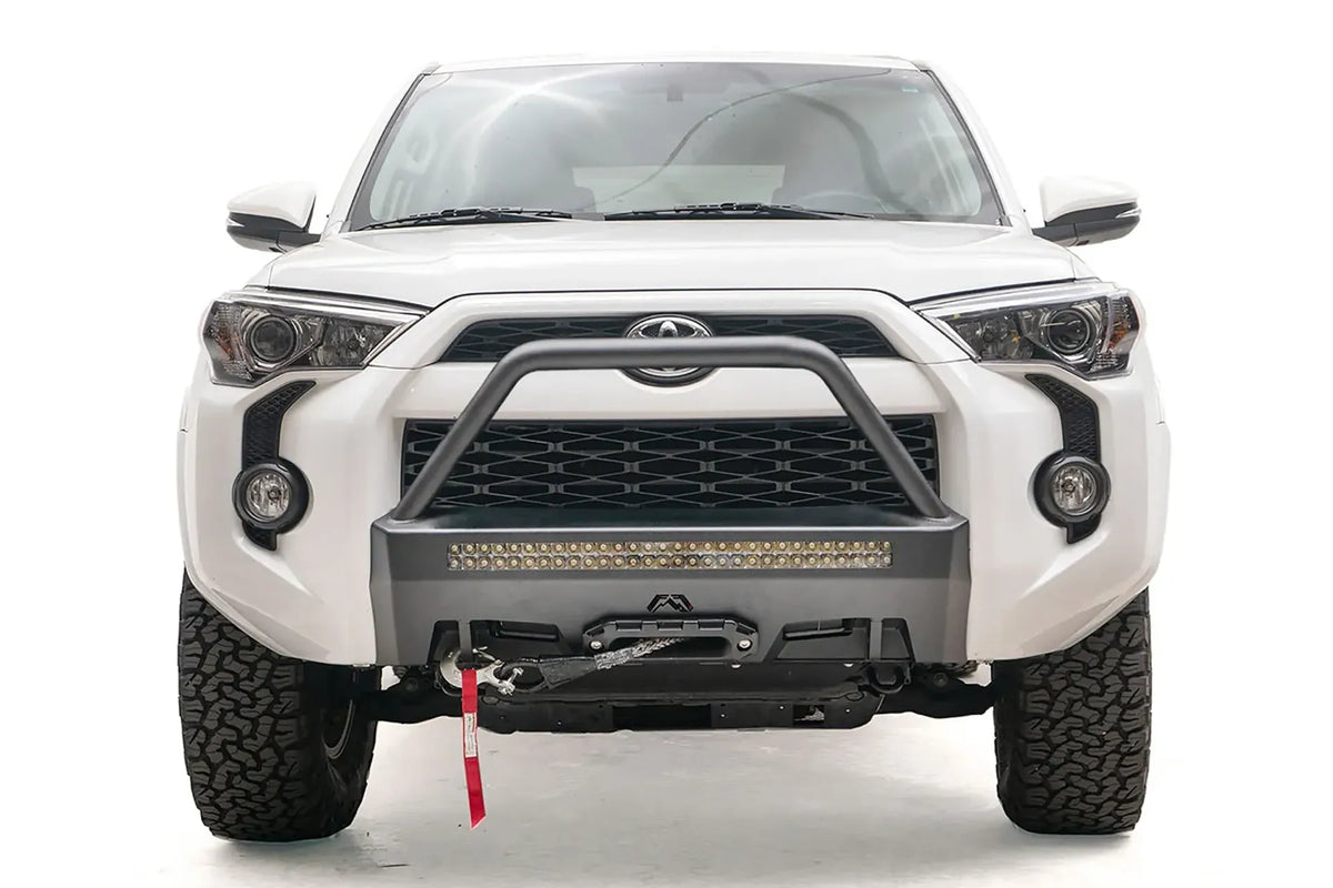 Fab Fours Hidden Winch Mount with high pre-runner guard on a white Toyota 4Runner, front view, showing the high pre-runner hoop, LED light bar and winch fairlead