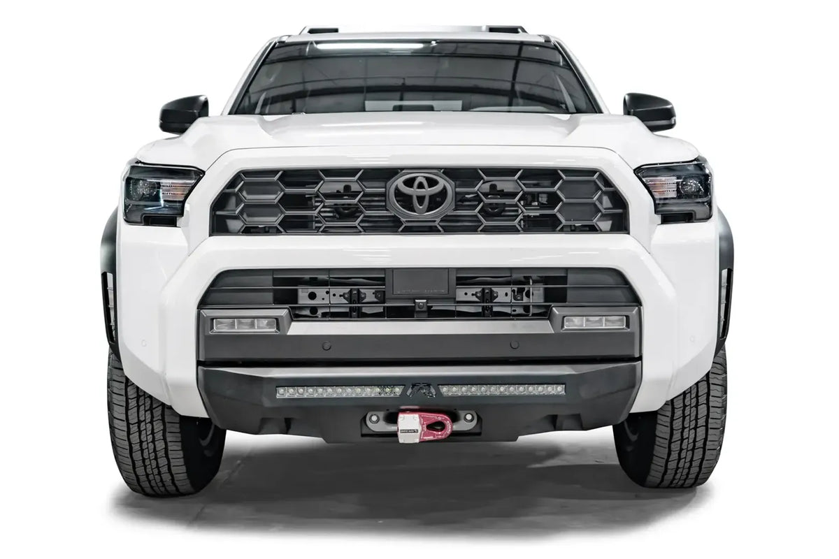Fab Fours Semi-Hidden Winch Mount on a white Toyota 4Runner, front view, showing the full-width plate, LED light bar and red shackle mount