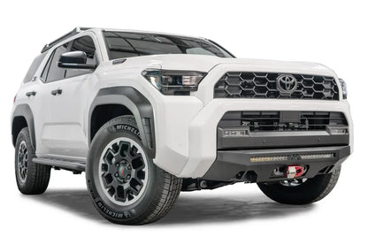Fab Fours Semi-Hidden Winch Mount on a white Toyota 4Runner, front three-quarter view from the passenger side, showing the low-profile bumper plate, LED light bar and red shackle mount