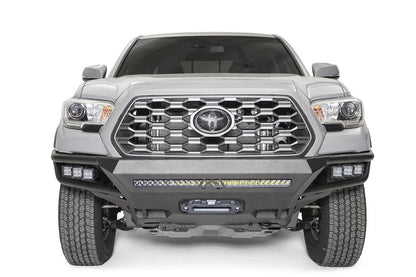 Fab Fours Hybrid front bumper on a silver Toyota Tacoma, front view, showing the LED light bar, cube lights and centre winch opening