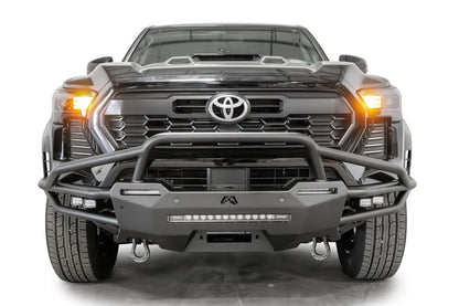 Fab Fours Hybrid front bumper with pre-runner guard on a black Toyota Tacoma, front view, showing the pre-runner hoop, LED light bar and D-ring shackles