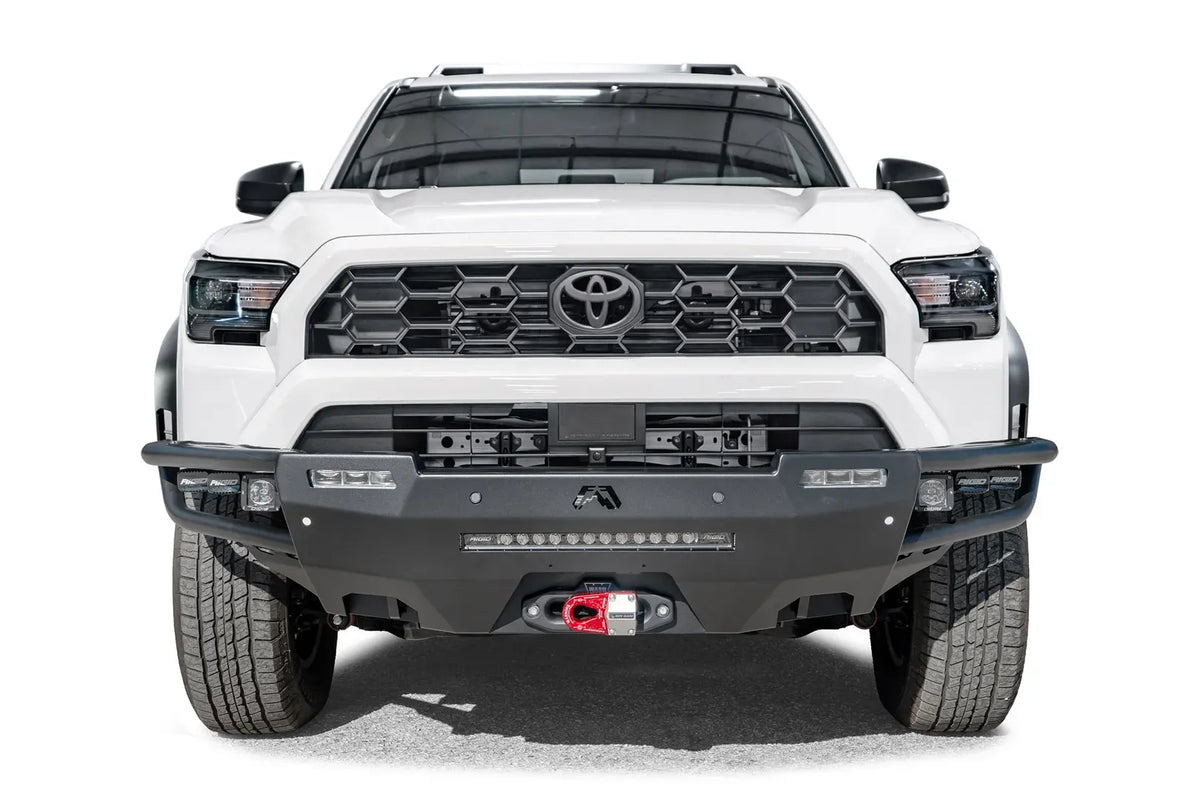 Fab Fours Hybrid front bumper on a white Toyota 4Runner, front view, showing the tube wings, LED light bar and red winch shackle mount