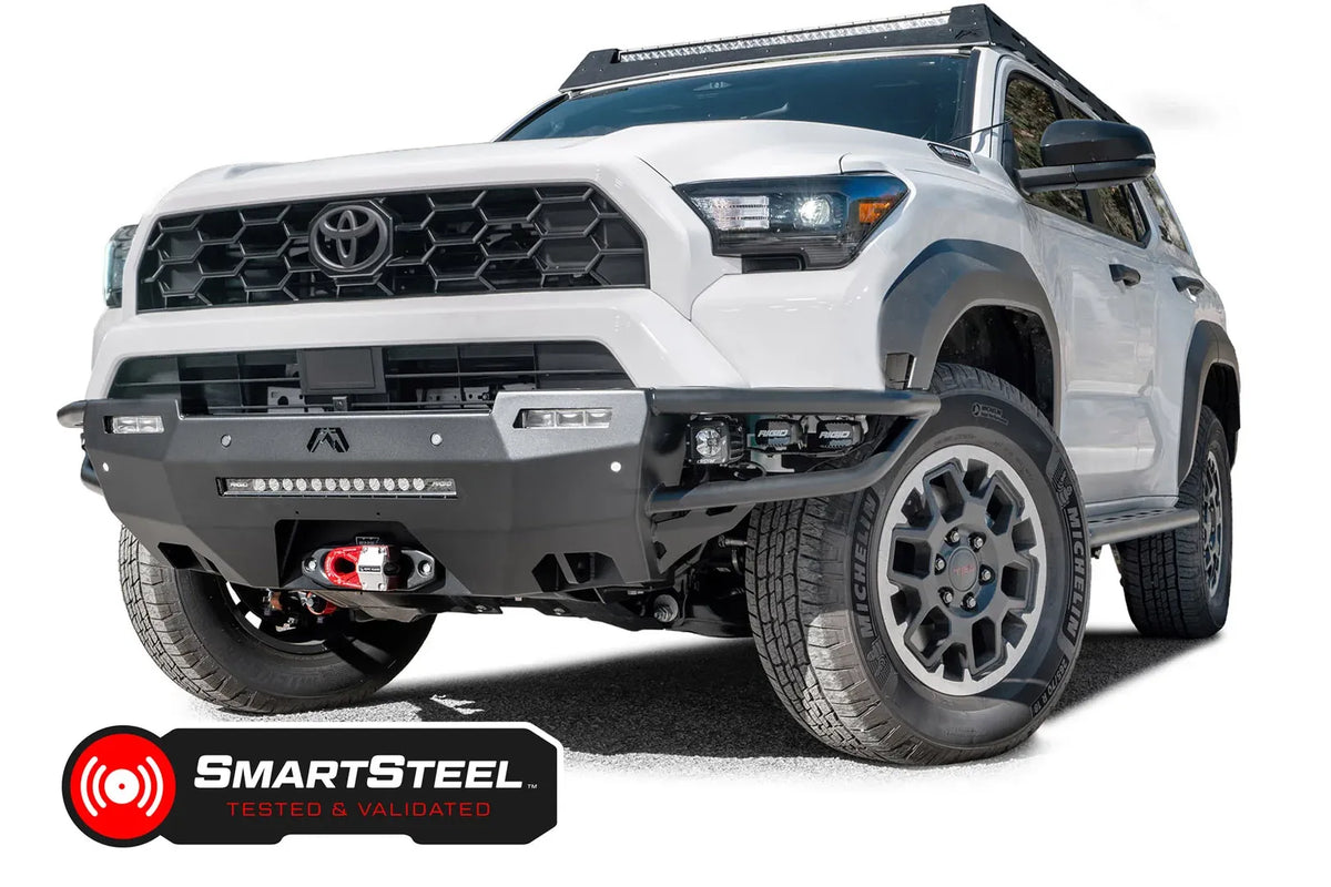 Fab Fours Hybrid front bumper on a white Toyota 4Runner, front three-quarter view from the passenger side, showing the tube wings, LED light bar and cube lights