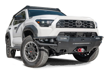 Fab Fours Hybrid front bumper on a white Toyota 4Runner, front three-quarter view from the passenger side, showing the tube wings, LED light bar and cube lights