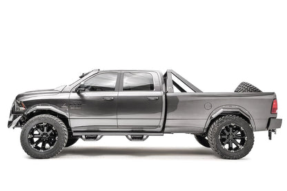 Fab Fours Open Fender System on a gray Ram 2500 crew cab, driver-side profile view, showing the open front and rear fenders, raised wheel openings and bolt-on fender trim