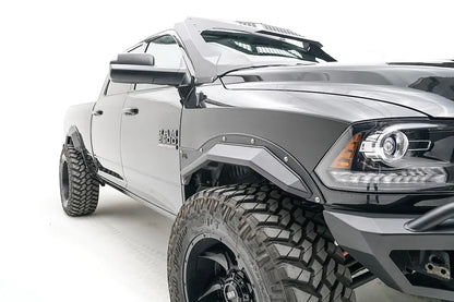 Fab Fours Open Fender Flares on a black Ram 2500 crew cab, close-up of the front fender, showing the front open fender flare, bolt detail and tire clearance