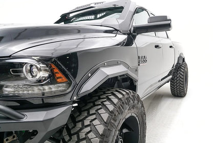 Fab Fours Open Fender Flares on a black Ram 2500 crew cab, close-up of the front fender, showing the front open fender flare and exposed bolts